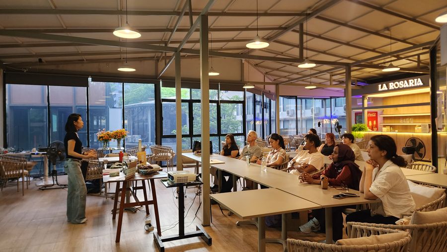 Tammie leading a cooking workshop in a bright café