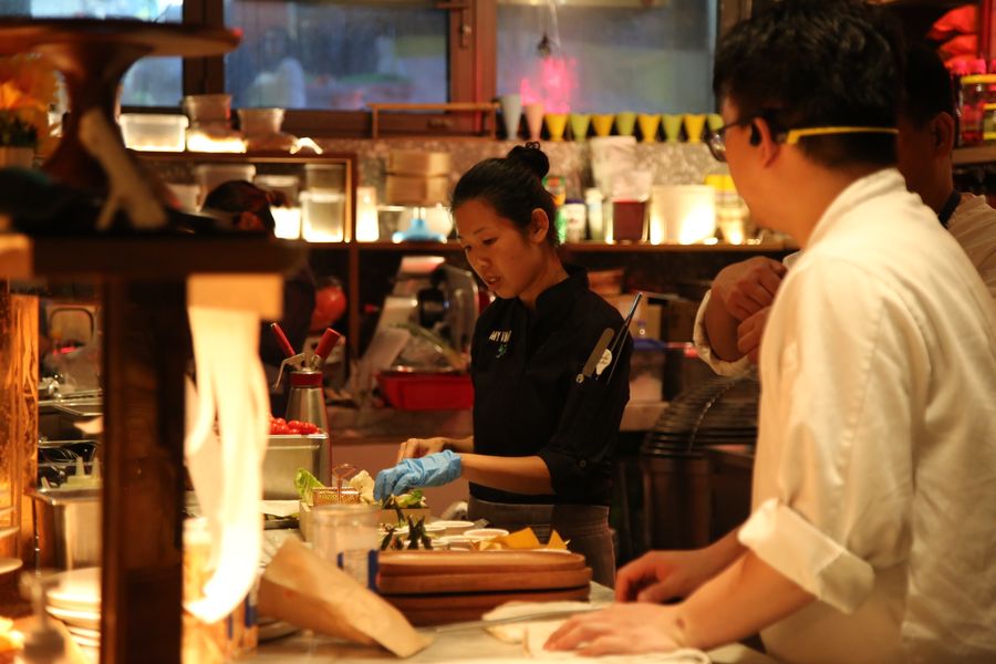 Tammie cooking in a busy restaurant kitchen