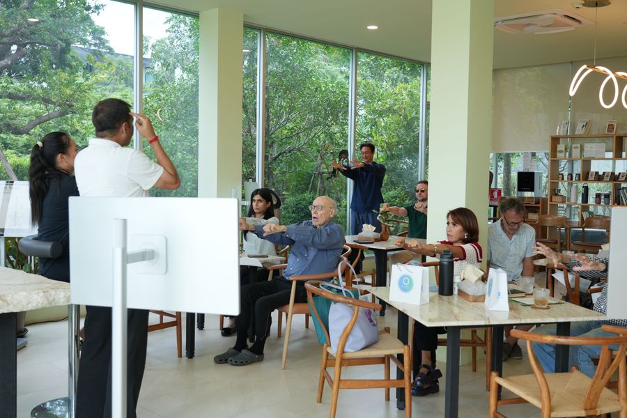 Guests following a mindful movement session in AMSEL's bright, garden-facing room