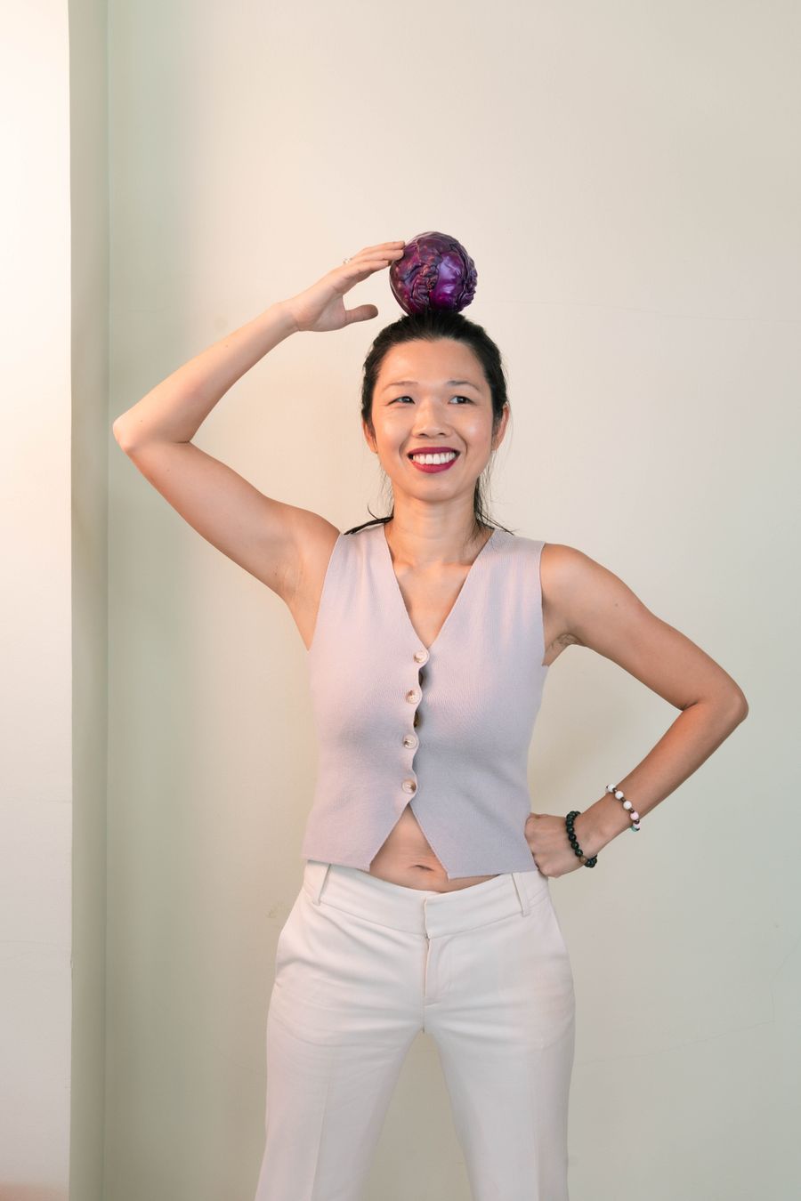 Tammie laughing, balancing a red cabbage on her head
