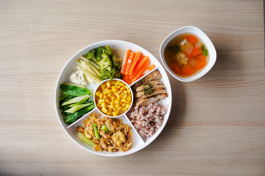 A Kensington school lunch plate: rice, corn, vegetables and a small bowl of soup