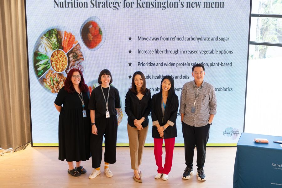 Tammie with the Kensington team in front of a slide on the school's new menu nutrition strategy