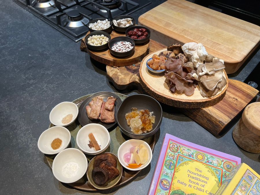 A spread of small dishes and ingredients on a wooden board
