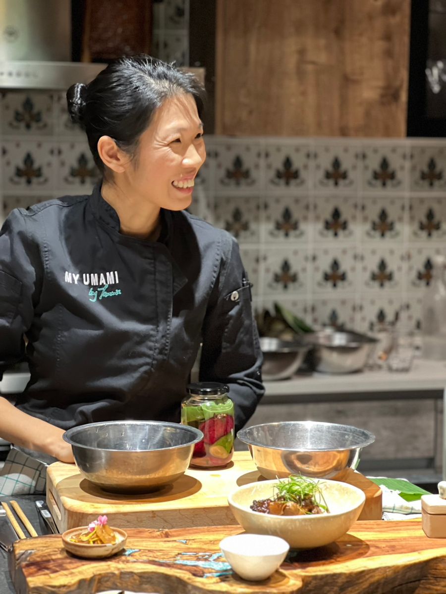 Tammie cooking and laughing at a demonstration at Bo.lan